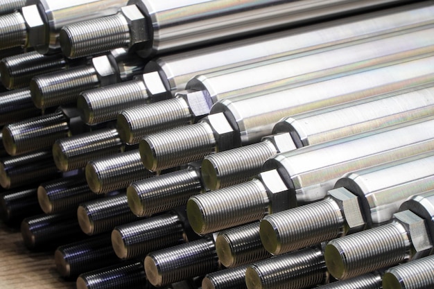 Shiny steel parts closeup background long clean steel rods after fine cnc turning