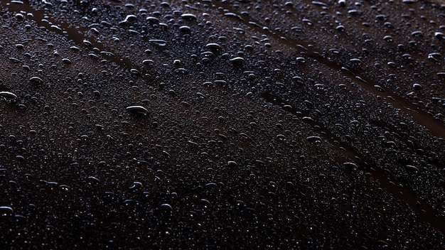 Shiny water drops on black surface, background abstract