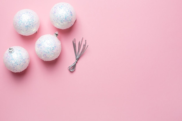 Shiny white balls on a pink background