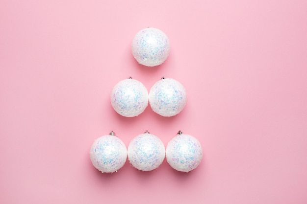 Shiny white balls on a pink background