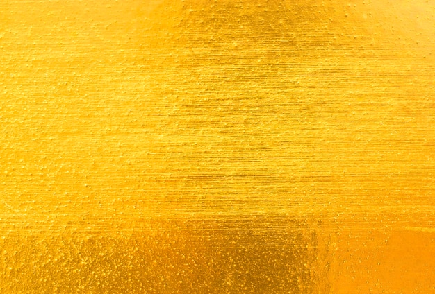 光沢のある黄色い葉の金箔のテクスチャの背景
