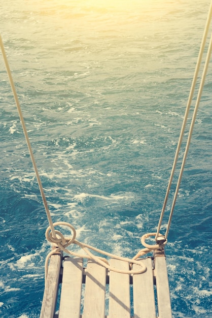 Ship ladder against the sea with sunlight