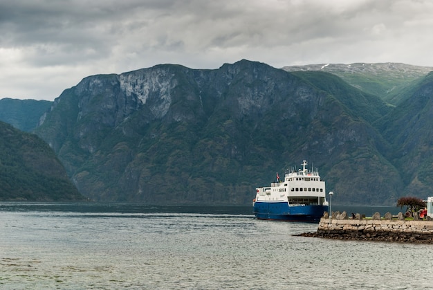 Ship near the pier in the Aurlandsfjord fjord. It is a fjord in Sogn og Fjordane county, Norway, a branch of the main Sognefjorden. Length 29 km