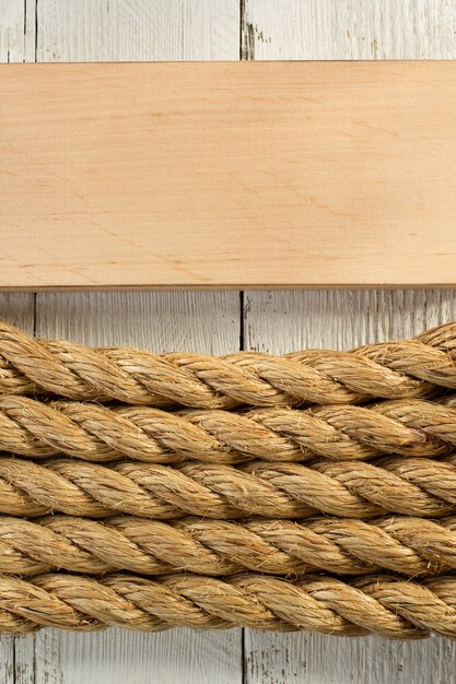 Ship rope on wooden background