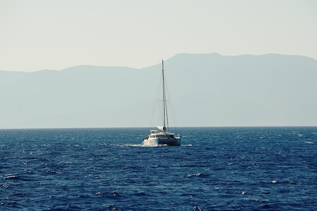 Ship sailing on sea against clear sky