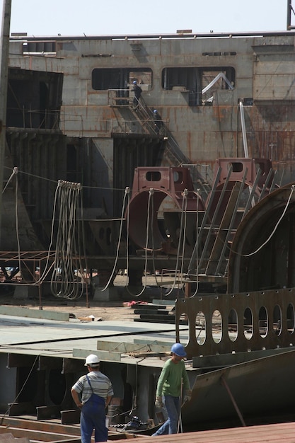 Shipbuilding pier and crane Workers working on the pier