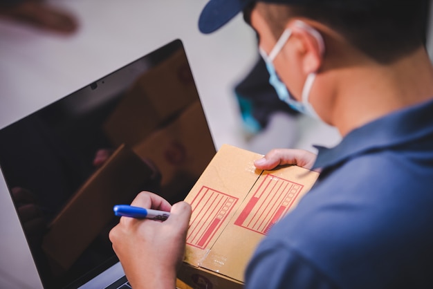 Shipping Online Shopping Small Business Owners Write on Cardboard Boxes at Work for Small SME Entrepreneurs Impact of the Crisis Covid-19 Online Sales Business