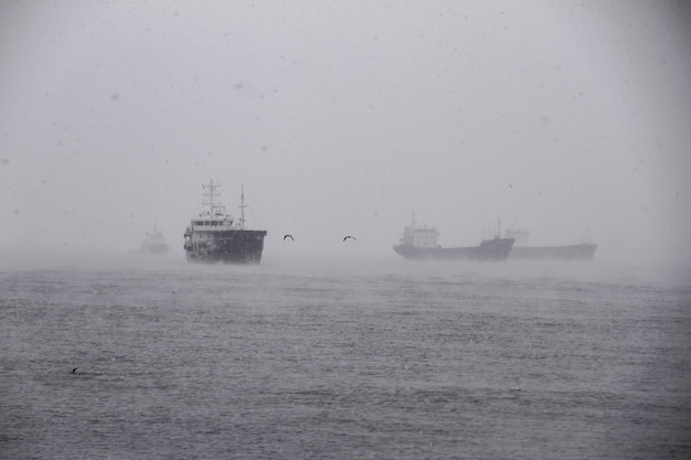 Ships anchored in the open sea in stormy weather