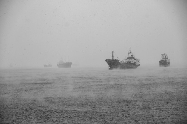 Ships anchored in the open sea in stormy weather