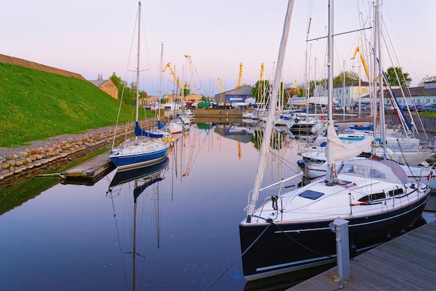 Ships at embankment of Dane River at Old town of Klaipeda in Lithuania, Eastern European country on the Baltic sea