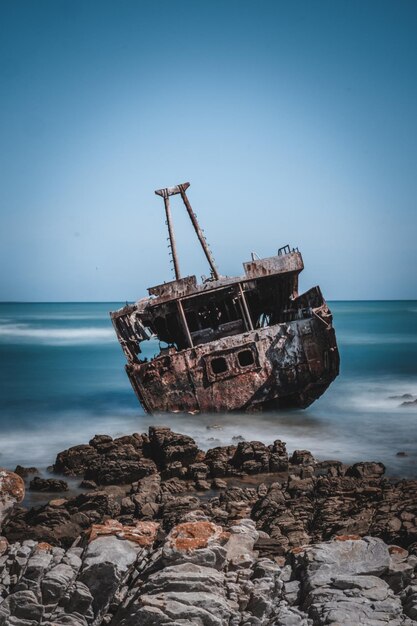 写真 空の向こうのビーチで沈没した船