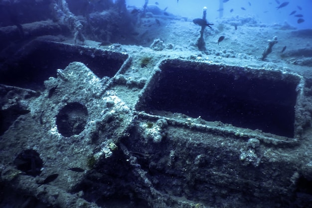 Photo shipwreck in the blue water rusty shipwreck with growing corals underwater