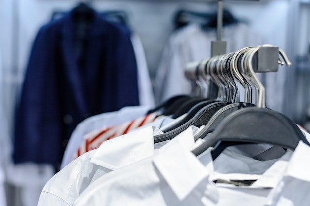 Shirt carelessly hanging on the rack in the store. closeup.