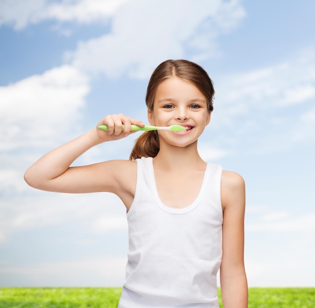 shirt design, health, oral hygiene, dental concept - smiling teenage girl in blank white shirt brushing her teeth