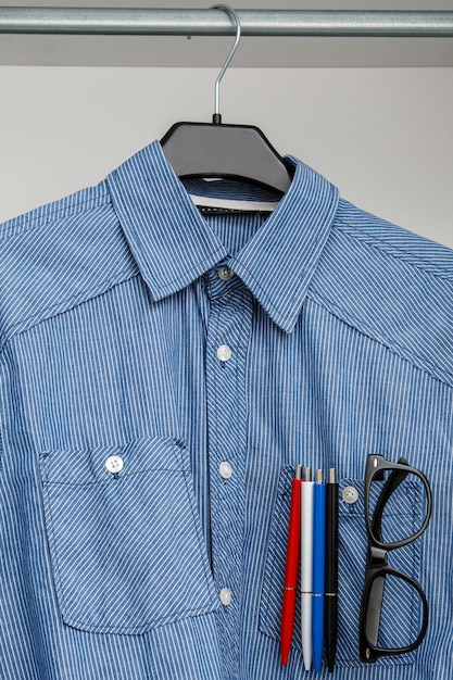 Shirt with colorful pens and eyeglasses in pocket