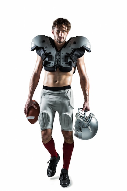 Photo shirtless american football player with padding holding ball and helmet