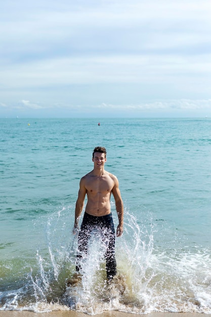 Shirtless man at beach during vacation