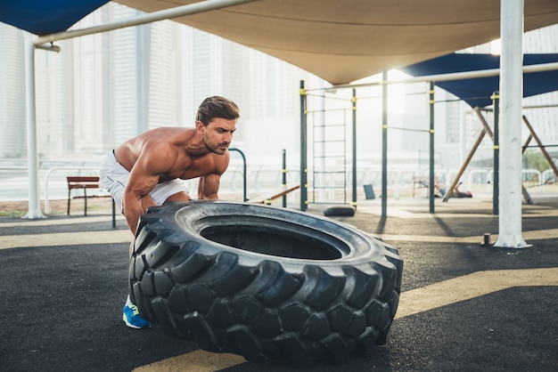 Shirtless man doing work out and different exercises outdoor