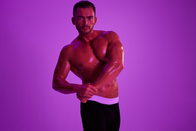 Shirtless man exercising against blue background