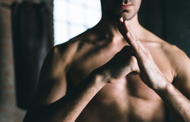 Shirtless man at gym, martial arts concept