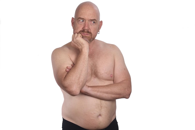 shirtless man looking side on white background