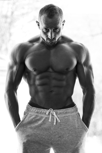 Shirtless man standing against white background