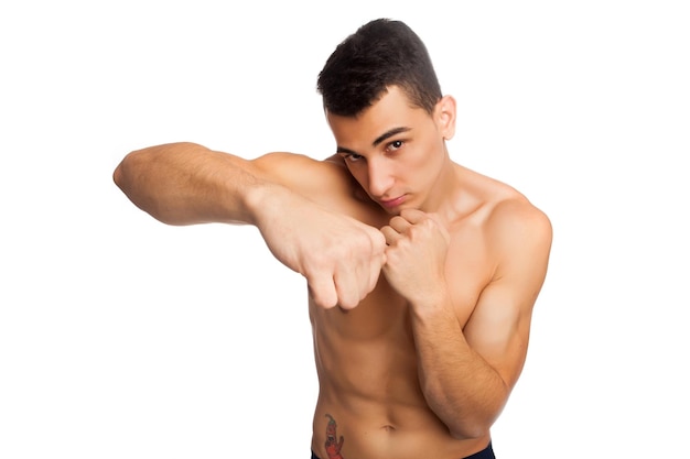 Shirtless man with sports figure boxing in studio