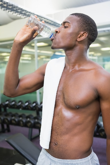 Shirtless mensen drinkwater bij gymnastiek