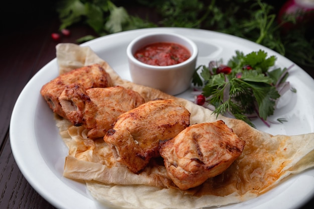 Shish kebab of chicken on a white plate