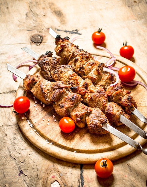 Shish kebab on skewers with tomato.