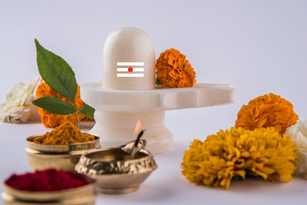 Pooja 또는 Lord shiva 또는 Shankar bhagwan 숭배를 위해 꽃과 bel patra 또는 잎과 haldi kumkum으로 장식 된 Shiva Linga