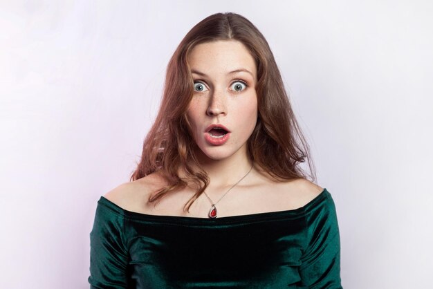 Shocked astonished woman looking at camera with big eyes and open mouth being very surprised