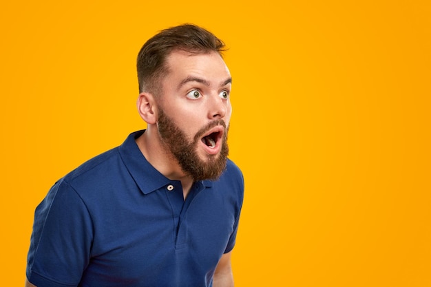 Shocked bearded male looking away