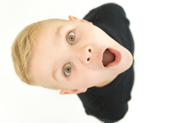 The shocked boy look to the camera. View from above