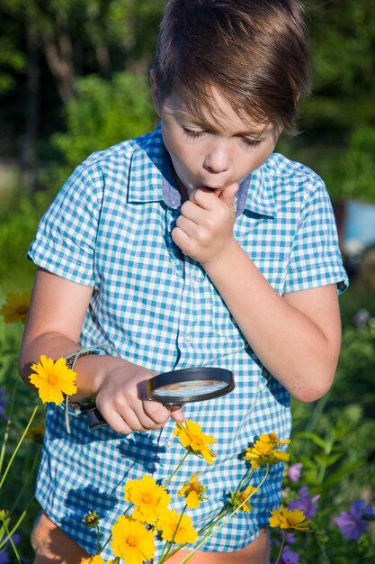 Shocked boy with magnifying glass