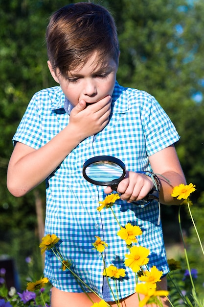 Shocked boy with magnifying glass