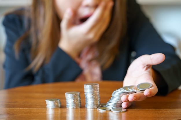 Photo shocked business woman with stack coins - stock and market down.