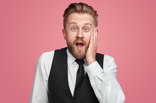 Shocked businessman looking at camera in studio