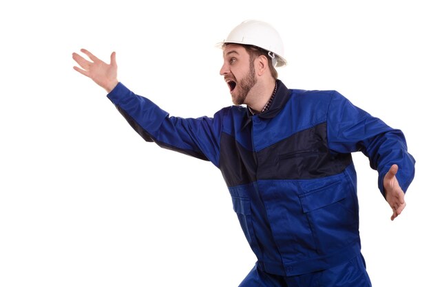 Shocked civil engineer in a protective white helmet and blue uniform