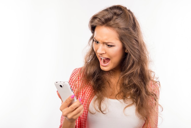 Shocked frustrated young woman with phone isolated