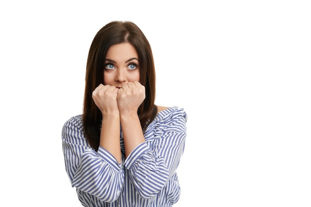 shocked girl covering her face with hands isolated on white