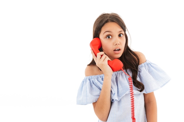 Shocked girl talking by telephone.