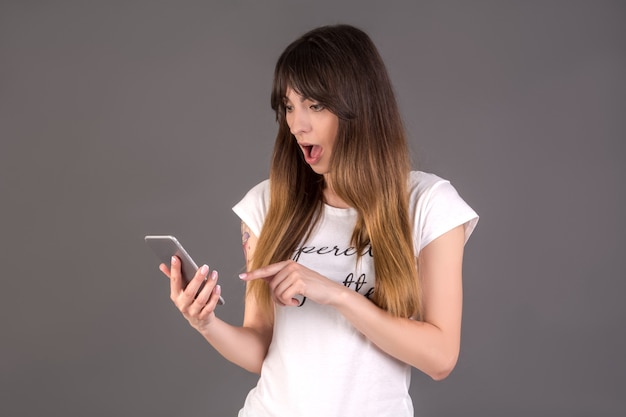 Shocked girl with mobile phone