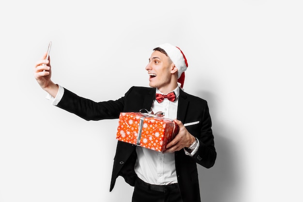 Shocked guy in a suit and a santa hat