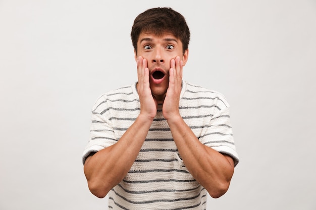 Premium Photo | Shocked handsome man standing isolated on white wall.