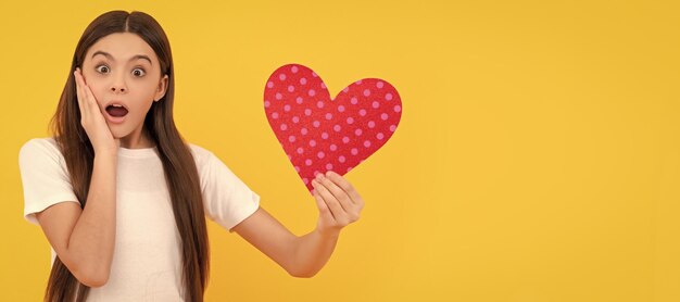 Shocked kid with love romantic gift sweetheart valentines sale kid girl portrait with heart love symbol horizontal poster banner header with copy space