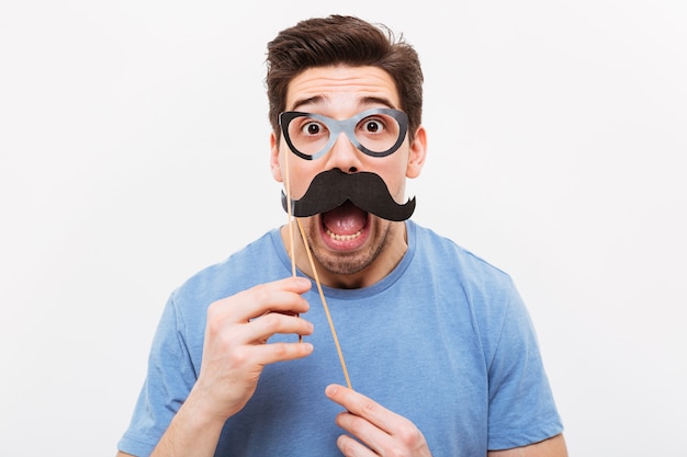 Shocked man in fake mustache and eyeglasses 