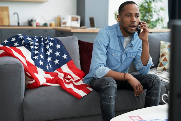 Shocked man having a phone conversation