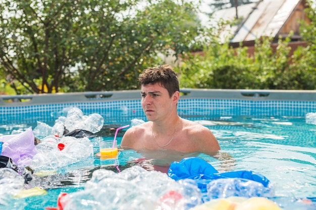 shocked man swim in a dirty swimming pool.