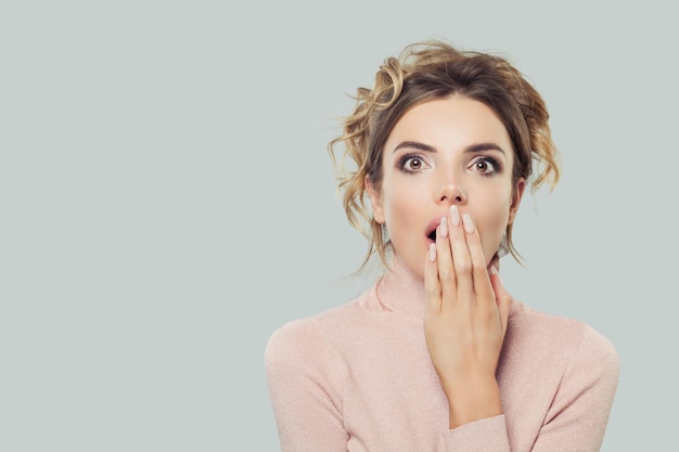 Shocked model woman with opened mouth portrait Surprised girl on background with copy space